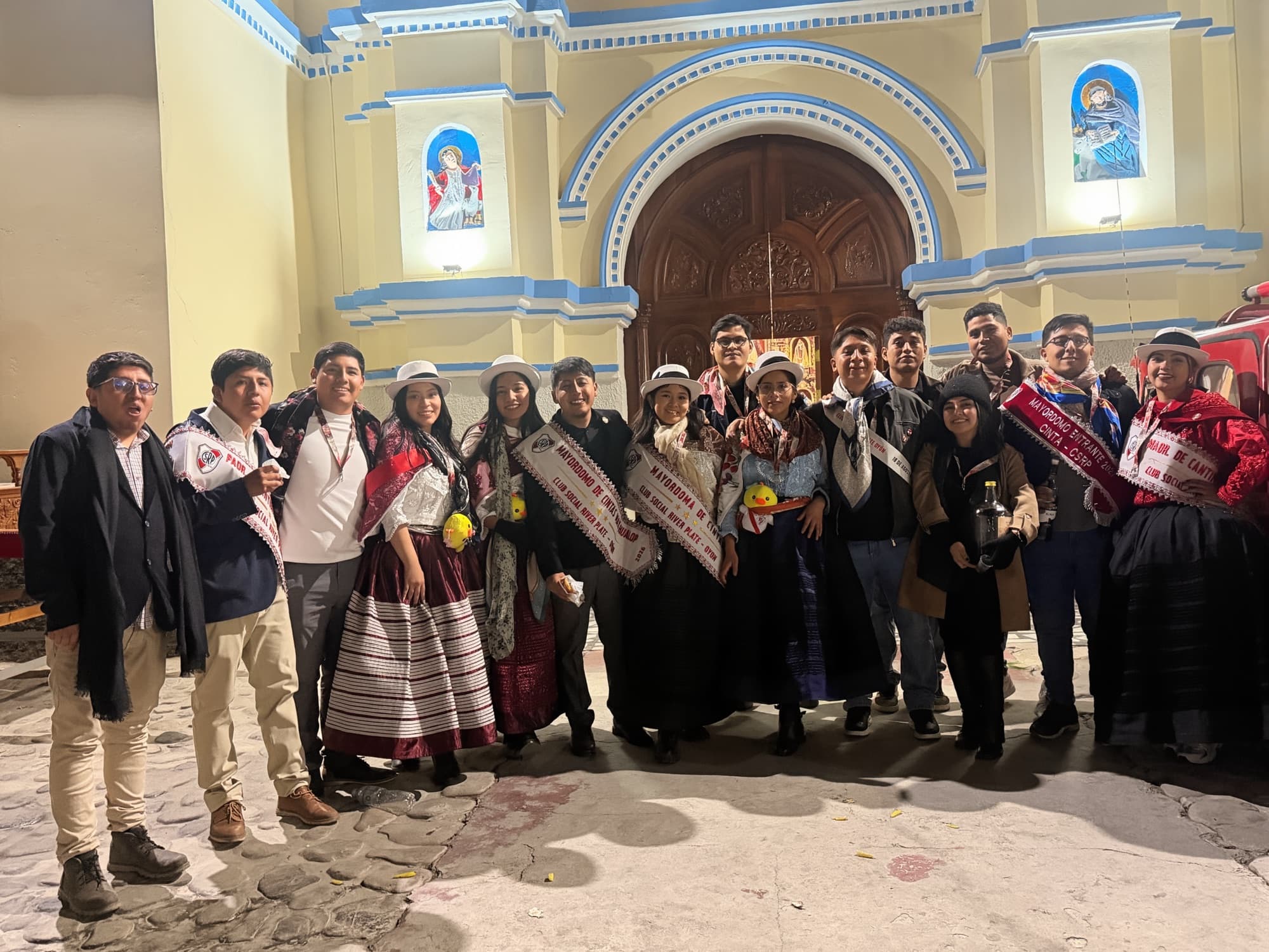 Group photo in front of the Oyón church: mayordomos, padrinos and friends with their sashes